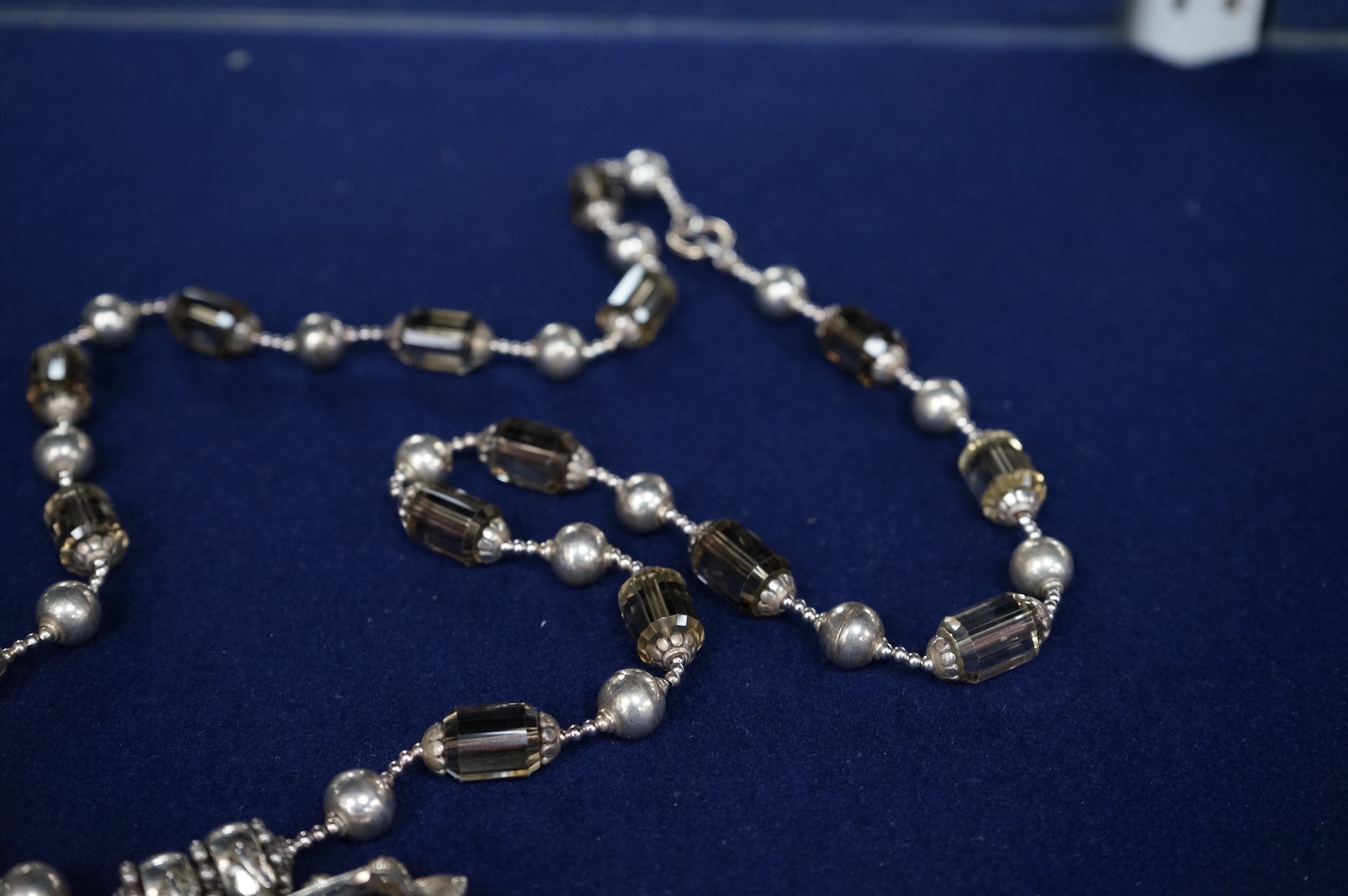 A white metal and quartz set drop pendant necklace, overall 90cm.